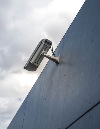 A security camera mounted on the outside of a commercial building