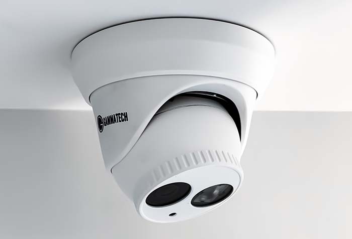 A dome security camera mounted on a ceiling