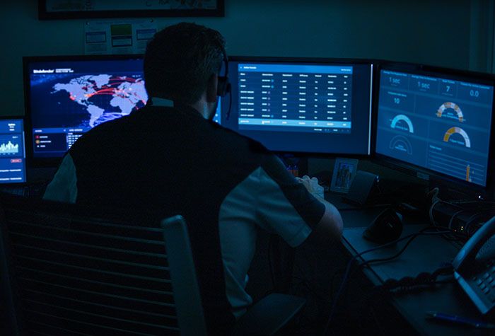 A Gamma Tech technician monitoring security dashboards