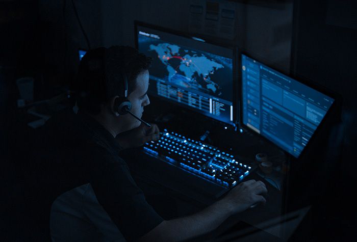 A Gamma Tech IT technician at a monitoring desk
