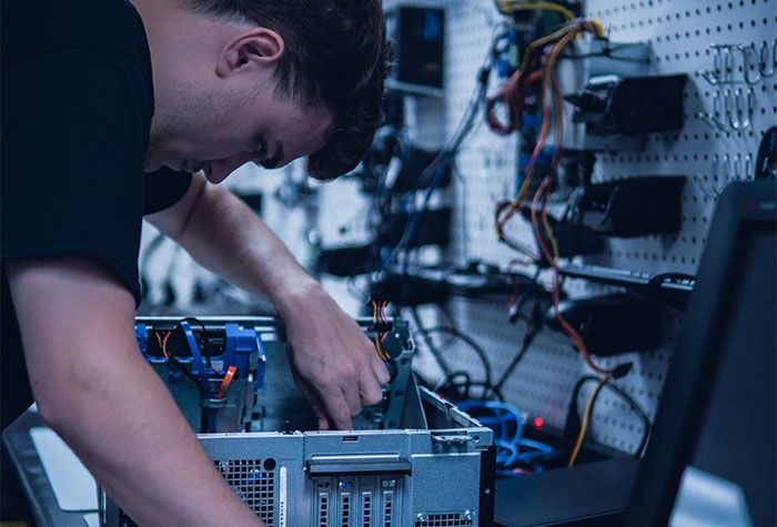 A Gamma Tech technician repairing a business computer