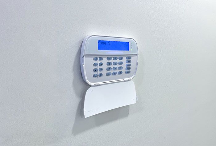 A wall-mounted alarm keypad