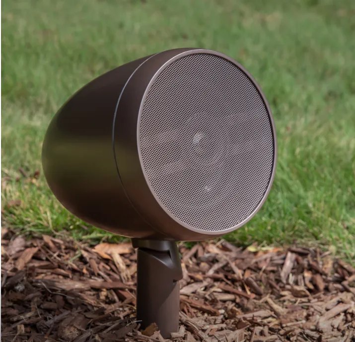 A bronze landscape speaker set among garden mulch