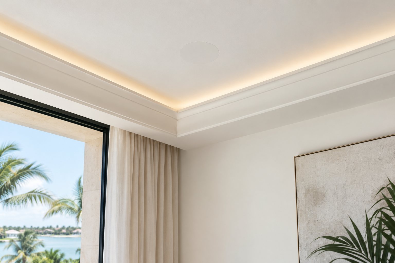 A smooth plaster ceiling with a speaker finished flush into it