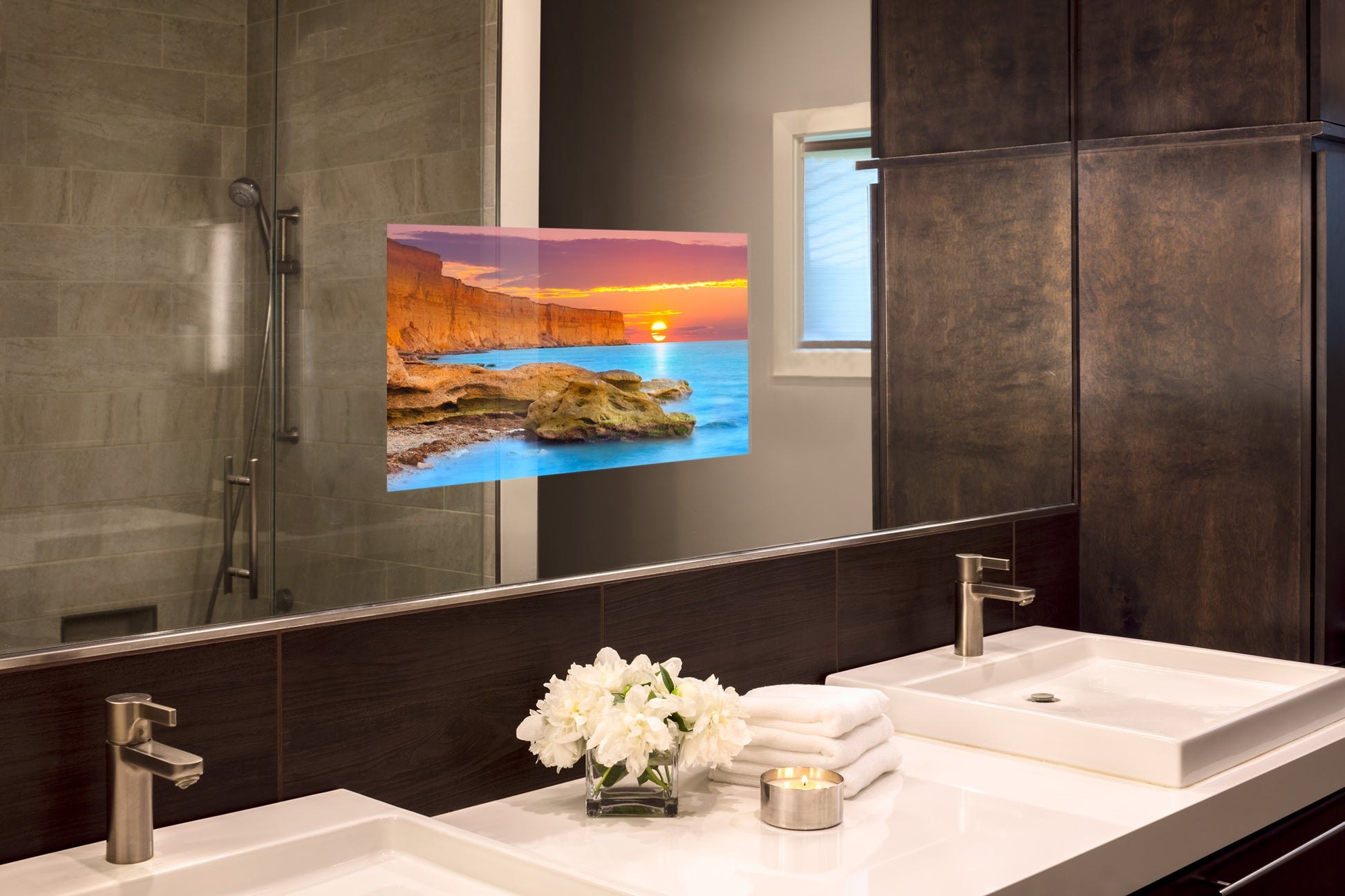 A Seura mirror TV showing a coastal sunset inside a primary bathroom mirror