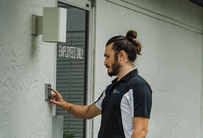 Gamma Tech employee entering his access code to enter a building