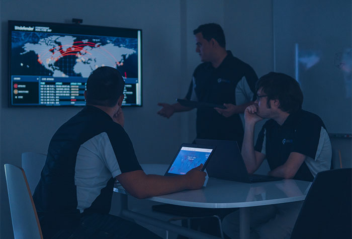 Cybersecurity technicians in conference room meeting